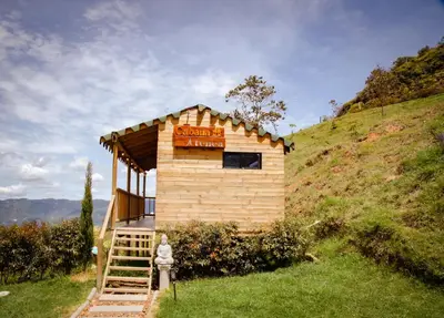 a small building on a hill with a fire hydrant at Tierra Escondida Glamping in Barbosa