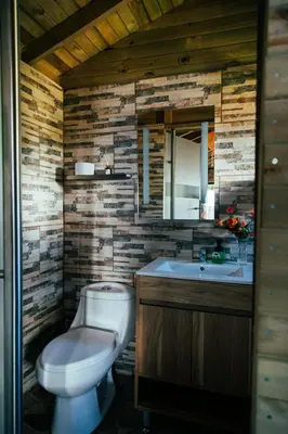 a bathroom with a toilet and a sink at Tierra Escondida Glamping in Barbosa