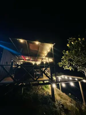 a night view of a shelter with lights on it at Tierra Escondida Glamping in Barbosa