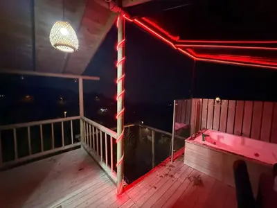 a room with a red light on a balcony at Tierra Escondida Glamping in Barbosa