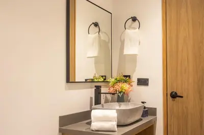 a bathroom with a sink and a mirror at Rosa Negra's Cozy Stadio Haven in Medellín