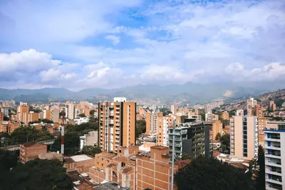 a view of a city with buildings and mountains at Stadio Serenity Suite | Rosa Negra in Medellín
