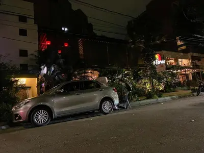 a silver car parked on the side of a street at night at Stadio Serenity Suite | Rosa Negra in Medellín
