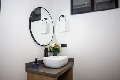 a bathroom with a white sink and a mirror at Rosa Negra Suite Near Stadium in Medellín