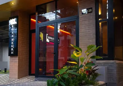 a front door of a building with a sign on it at Cozy Getaway | Rosa Negra Stadio Suite in Medellín
