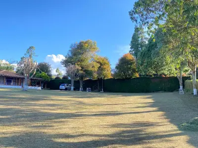 a large yard with trees and a house at Villa Ligia in Medellín