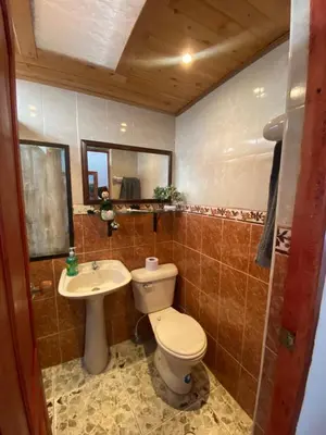 a bathroom with a toilet and a sink at Villa Ligia in Medellín