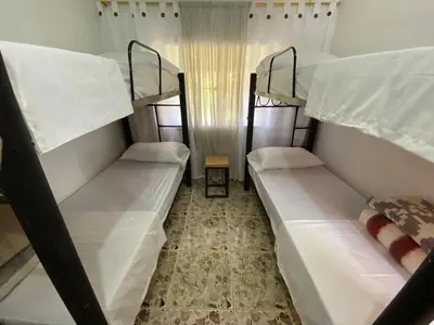 a room with three bunk beds in a hostel at Villa Ligia in Medellín