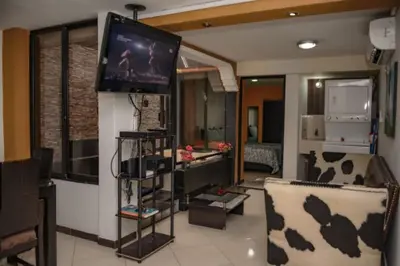 a living room with a flat screen tv on a wall at Calle 8 101 in Medellín