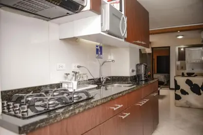 a kitchen with a sink and a microwave at Calle 8 101 in Medellín