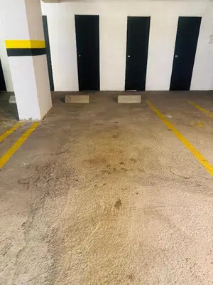 an empty parking garage with black and white doors at Mejor alojamiento cerca Provenza 191 in Medellín