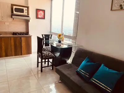 a living room with a couch and a table at Mejor alojamiento cerca Provenza 191 in Medellín