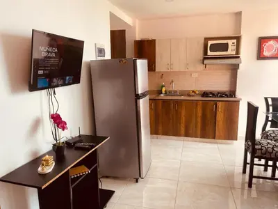 a kitchen with a stainless steel refrigerator and a table at Mejor alojamiento cerca Provenza 191 in Medellín