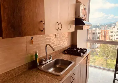 a kitchen with a sink and a large window at Mejor alojamiento cerca Provenza 191 in Medellín