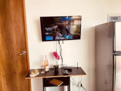 a flat screen tv hanging on a wall at Mejor alojamiento cerca Provenza 191 in Medellín