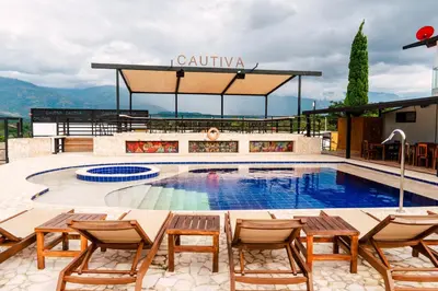 a pool on top of a building with chairs at Casa Hotel Cautiva in Sopetran