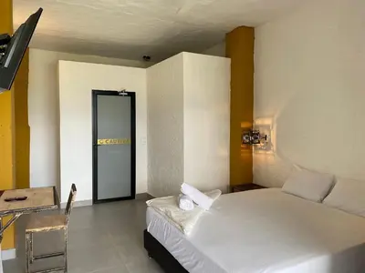 a bedroom with a bed and a door to a room at Casa Hotel Cautiva in Sopetran