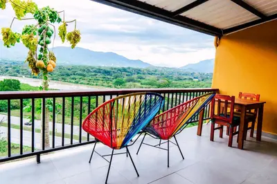 two chairs and a table on a balcony with a view at Casa Hotel Cautiva in Sopetran