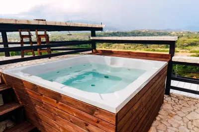 a jacuzzi tub on a deck with a view at Casa Hotel Cautiva in Sopetran