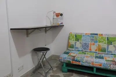 a couch in a room with a table and a stool at Living Poblado Manila 3020 Habitación Doble in Medellín
