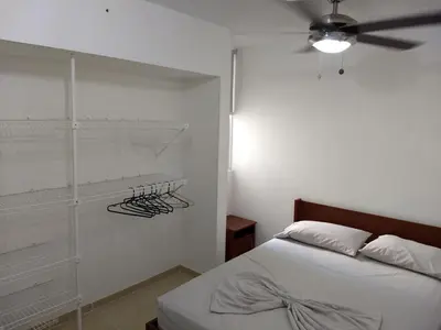 a bedroom with a bed and a ceiling fan at occidente Santa Fe de Antioquia sol y playa in Santa Fe de Antioquia