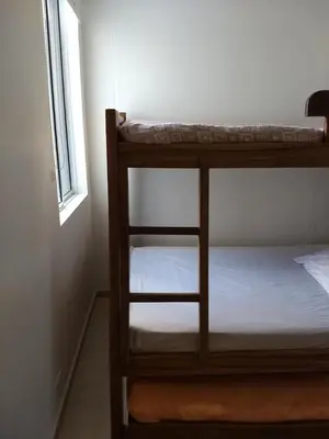 two bunk beds in a room with a window at occidente Santa Fe de Antioquia sol y playa in Santa Fe de Antioquia