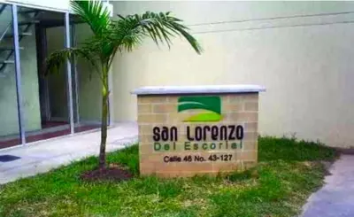 a sign in front of a building with a palm tree at Apartamento amoblado en Medellin! Solo Alquiler mensual!!! in Medellín