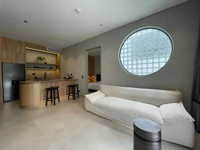 a living room with a white couch and a kitchen at Casa Tokyo 4 Manila - Terraza By Xcay Home in Medellín
