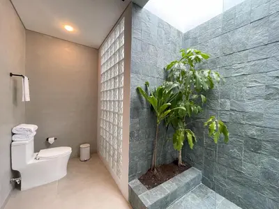 a bathroom with a toilet and a plant at Casa Tokyo 4 Manila - Terraza By Xcay Home in Medellín