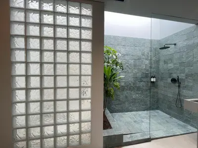 a bathroom with a shower and a glass door at Casa Tokyo 4 Manila - Terraza By Xcay Home in Medellín