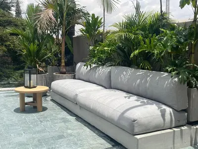 a couch sitting next to a table in a courtyard at Casa Tokyo 4 Manila - Terraza By Xcay Home in Medellín