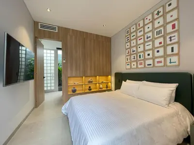 a bedroom with a large bed and a television at Casa Tokyo 4 Manila - Terraza By Xcay Home in Medellín