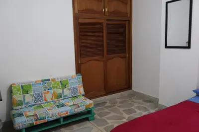 a room with a couch and a wooden door at Living Poblado Manila 3026 Habitación Individual in Medellín