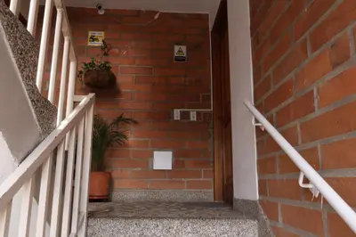 a staircase with a brick wall and a potted plant at Living Poblado Manila 3027 Habitación Individual in Medellín