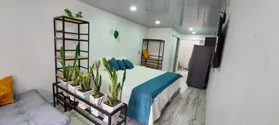 a bedroom with a bed with plants on it at Cómodo loft en Medellín in Medellín