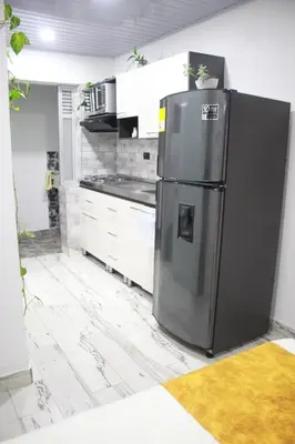a kitchen with a stainless steel refrigerator in a room at Cómodo loft en Medellín in Medellín