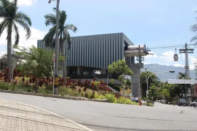 an empty street in front of a building with palm trees at Cómodo loft en Medellín in Medellín