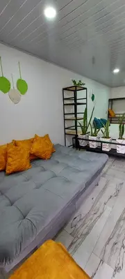 a large bed in a room with plants on the wall at Cómodo loft en Medellín in Medellín