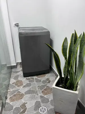 a potted plant sitting next to a small refrigerator at Cómodo loft en Medellín in Medellín