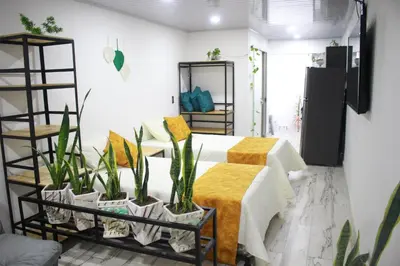 a room with a bed and some plants in it at Cómodo loft en Medellín in Medellín