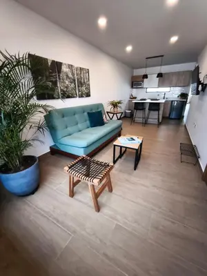 a living room with a blue couch and a table at Florentina Living 301 V in Medellín