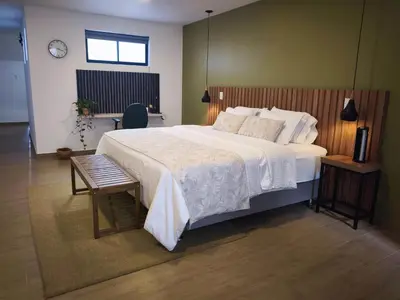 a bedroom with a large white bed and a chair at Florentina Living 301 V in Medellín