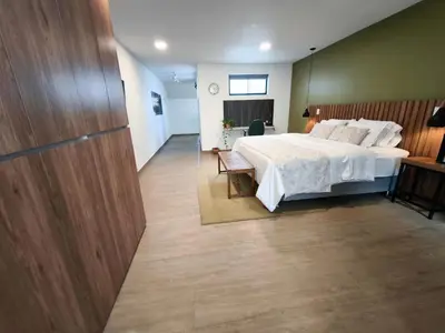 a bedroom with a white bed and a table and a chair at Florentina Living 301 V in Medellín