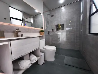 a bathroom with a toilet and a sink and a shower at Florentina Living 301 V in Medellín