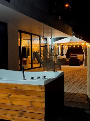 a jacuzzi tub in the middle of a wooden deck at Casa Fénix in Marinilla