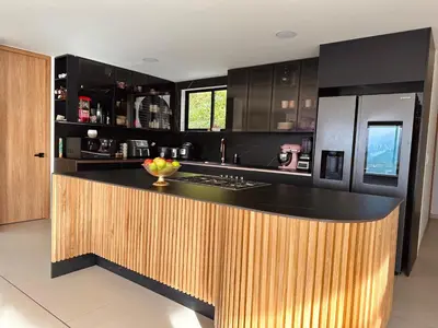 a kitchen with a black and wooden counter top at Casa Fénix in Marinilla