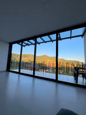 a room with a large window with a view at Casa Fénix in Marinilla