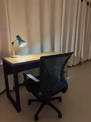 a desk with a chair and a lamp on it at Casa Fénix in Marinilla