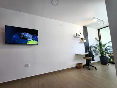 a living room with a tv on a wall at Florentina Living 302 A in Medellín