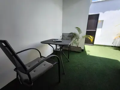 an empty office with a chair and a table and a plant at Florentina Living 302 A in Medellín